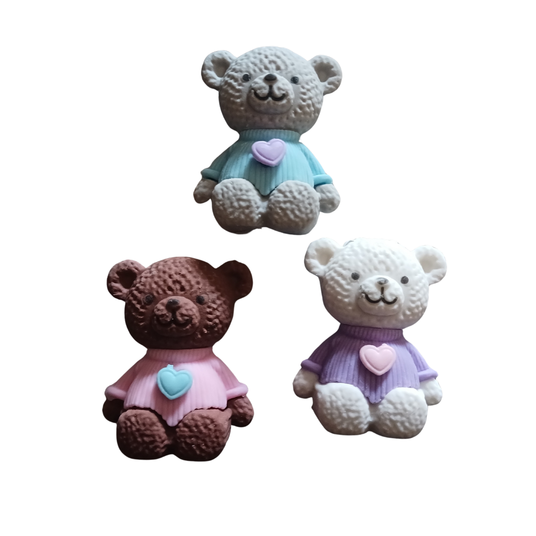 A group of colorful 3D bear puzzle erasers in various colors including blue, pink, and brown.