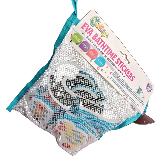Cooey EVA Bathtime Stickers packaged in a white mesh net attached to a cardboard header card, showing a purple toy car piece, a curved road track piece, and a traffic light piece lying on a wooden surface below.