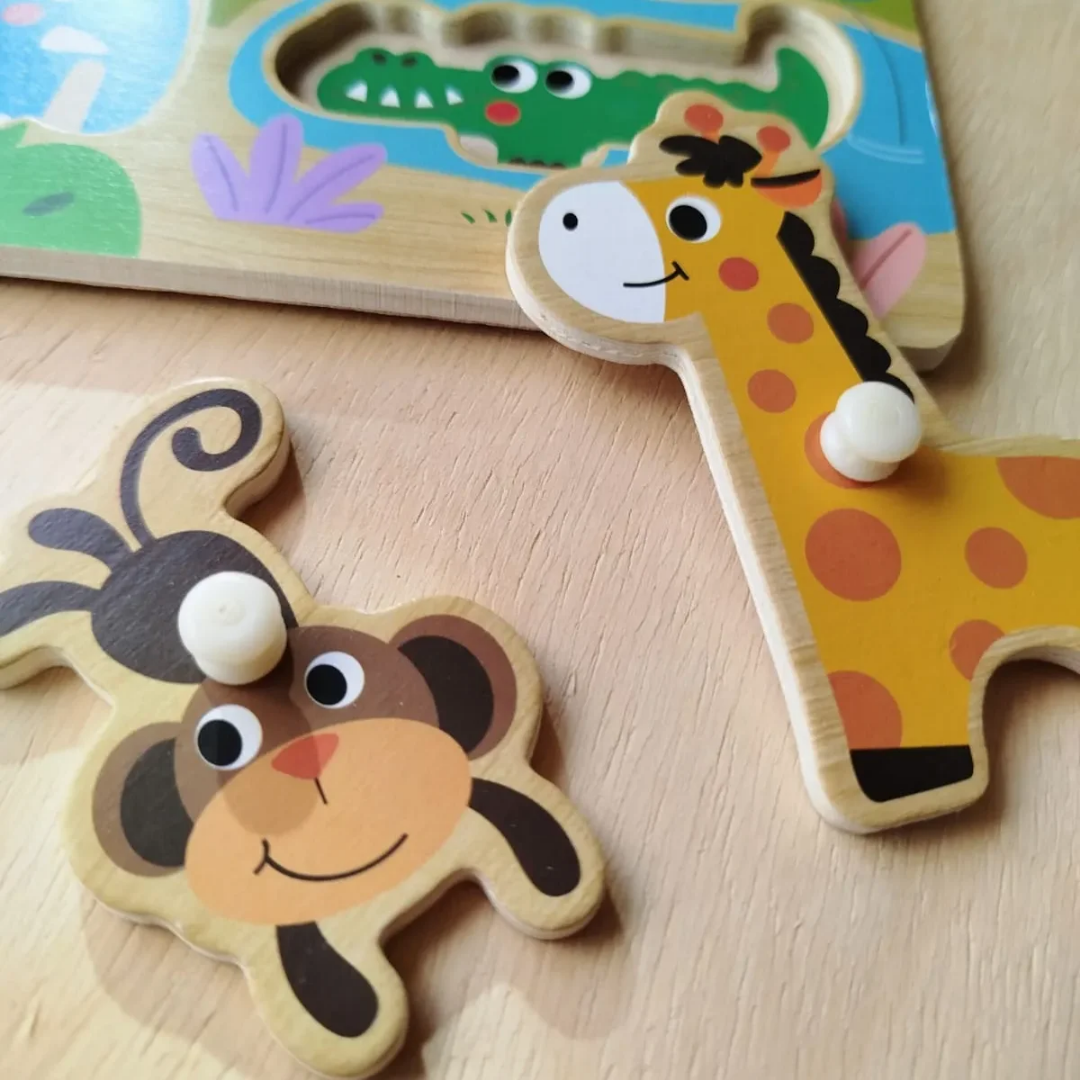 A wooden peg puzzle featuring colorful wild animals like a lion, elephant, and zebra with easy-to-grip knobs for toddlers.