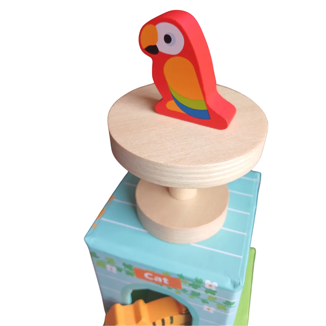 Three colorful wooden pet houses stacked with a wooden toy dog, cat, and rabbit sitting in front.