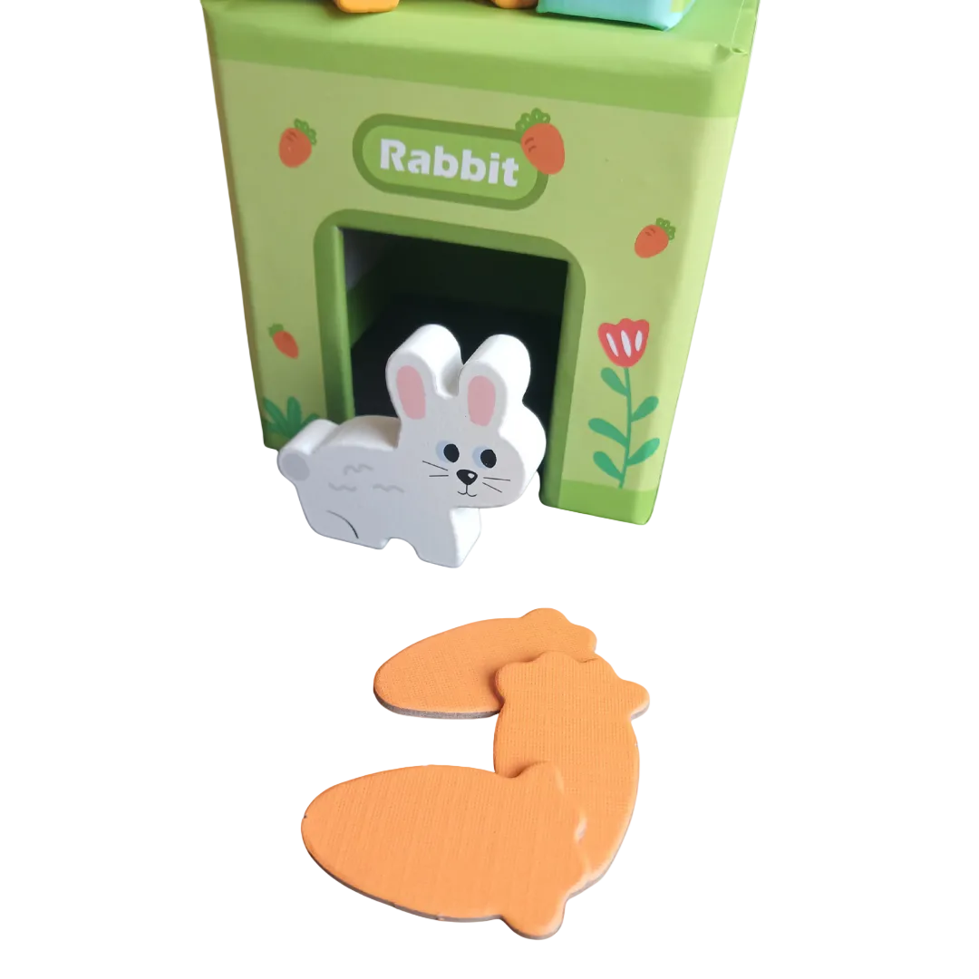 Three colorful wooden pet houses stacked with a wooden toy dog, cat, and rabbit sitting in front.