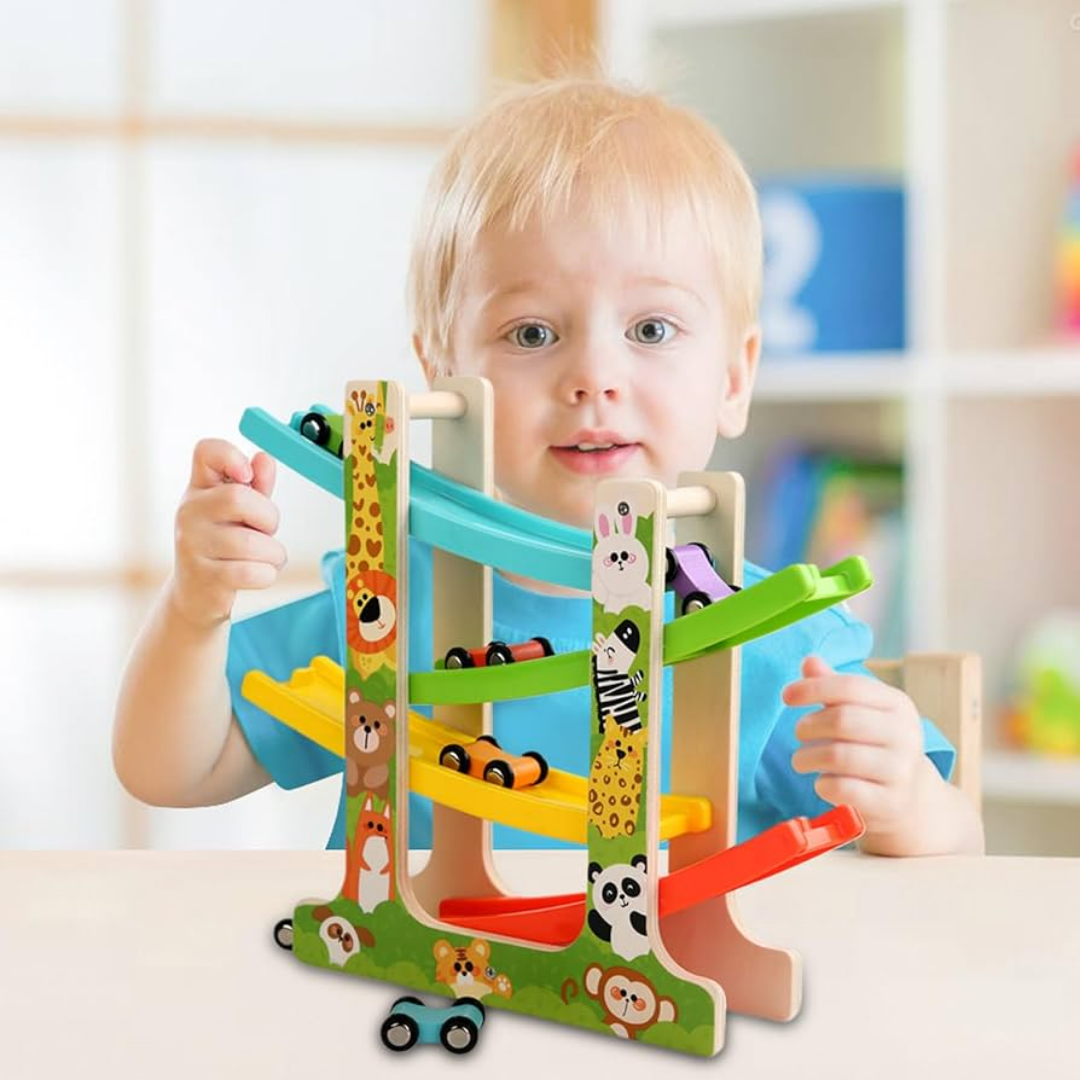 Toddler playing with a wooden ladder gliding car race track featuring four colorful ramps and animal illustrations.