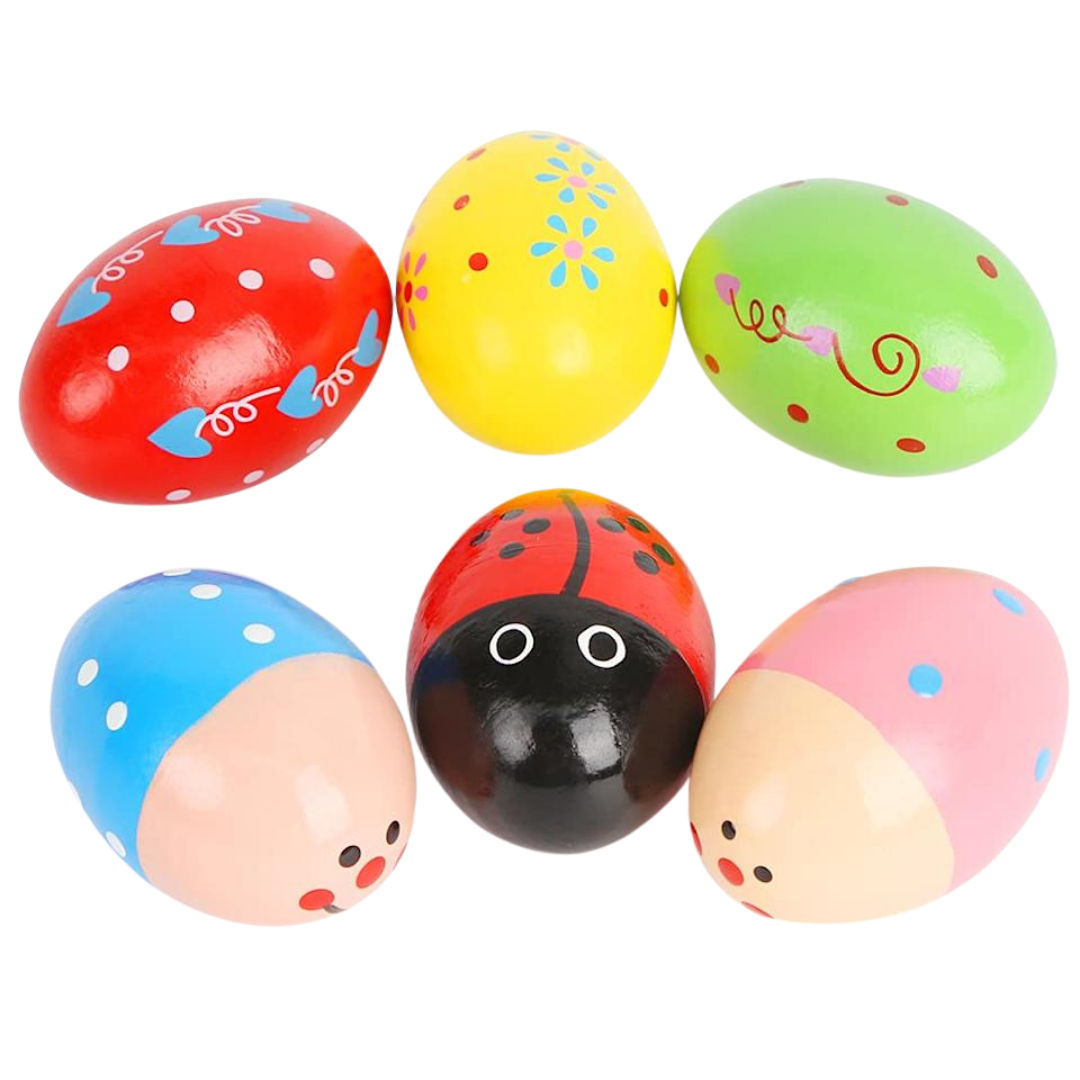 Little Band Wooden Egg Shakers showing unique painted styles including a red ladybug design, a yellow flower pattern, and a blue spotted design.