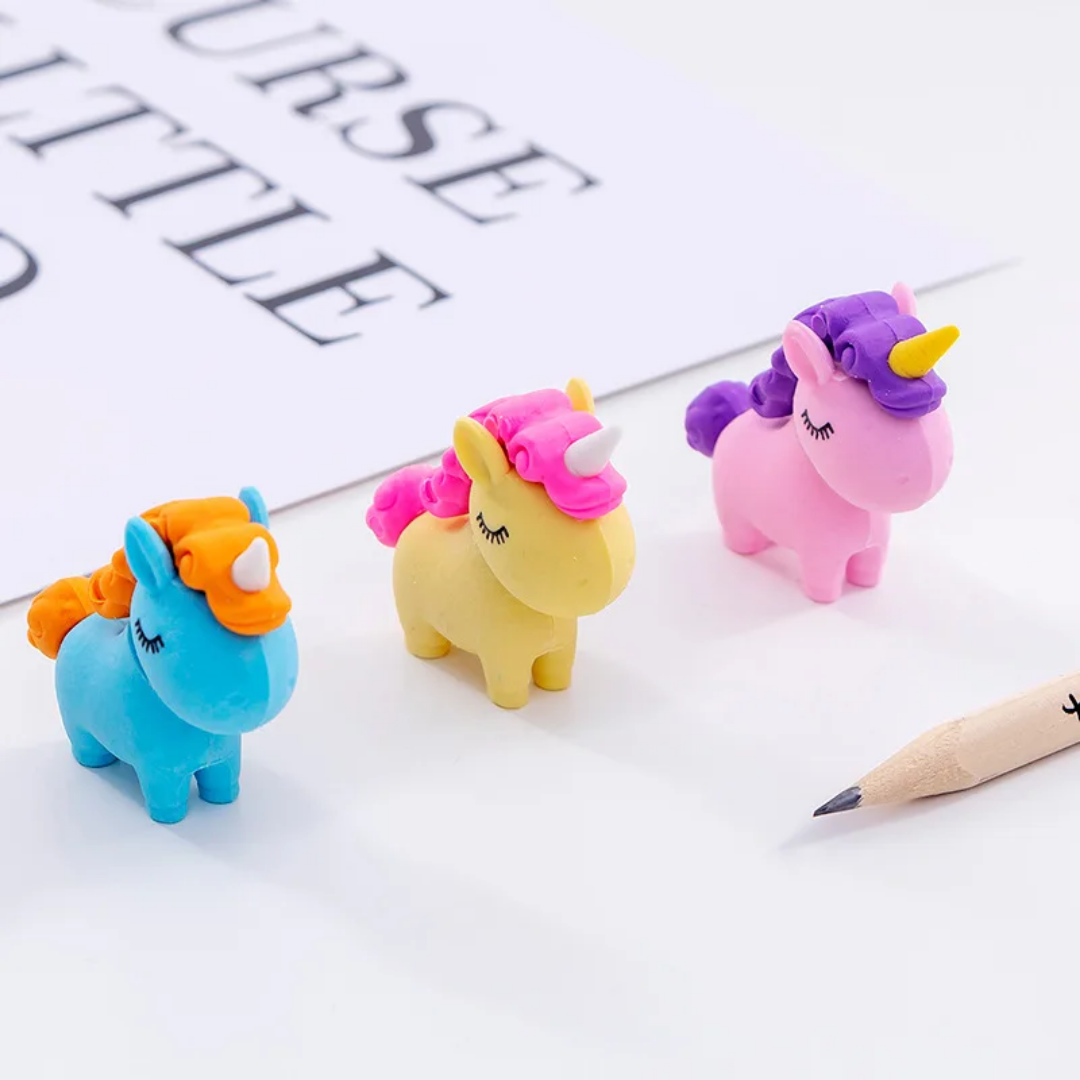 A collection of colorful 3D unicorn puzzle erasers in pastel pink, yellow, green, and blue.