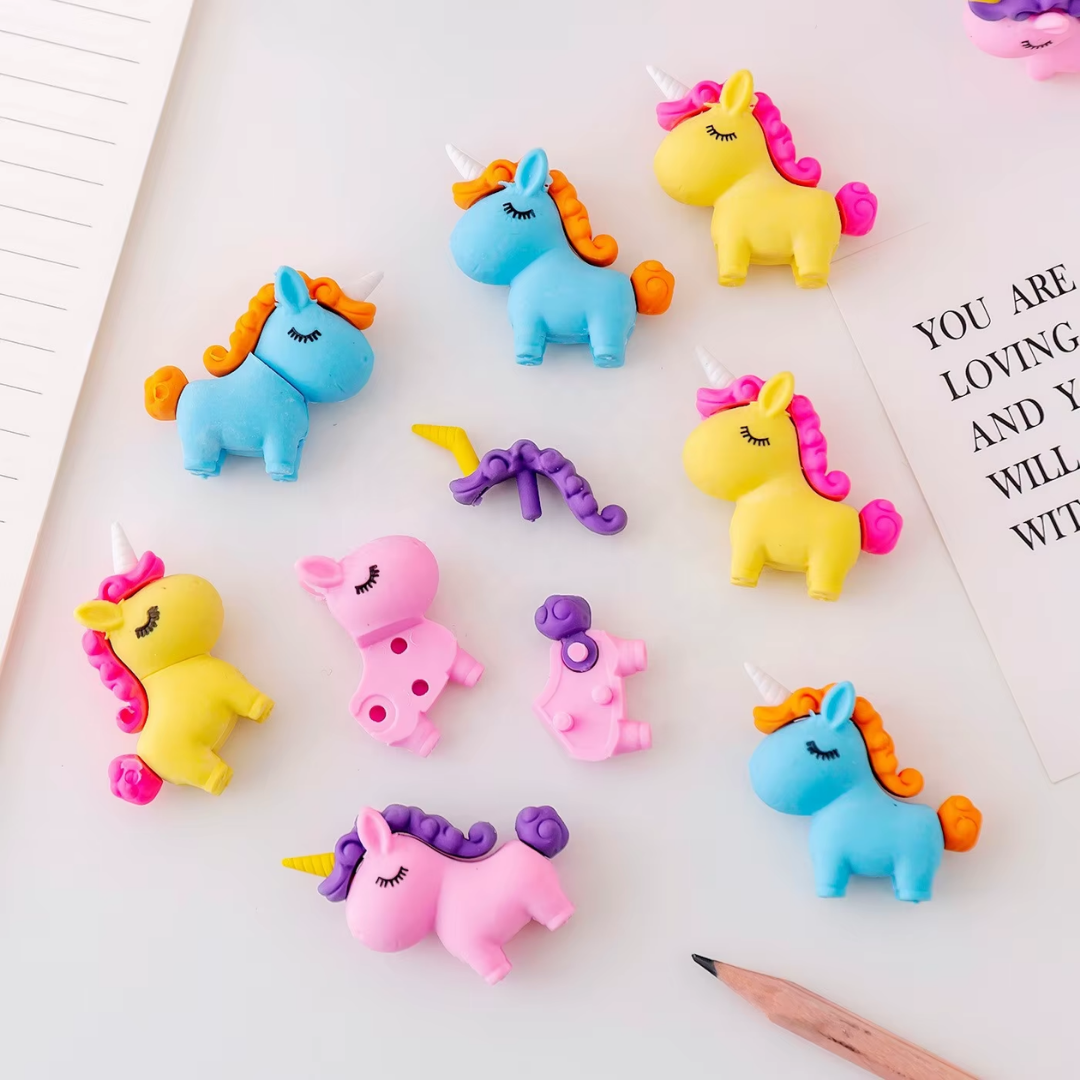 A collection of colorful 3D unicorn puzzle erasers in pastel pink, yellow, green, and blue.