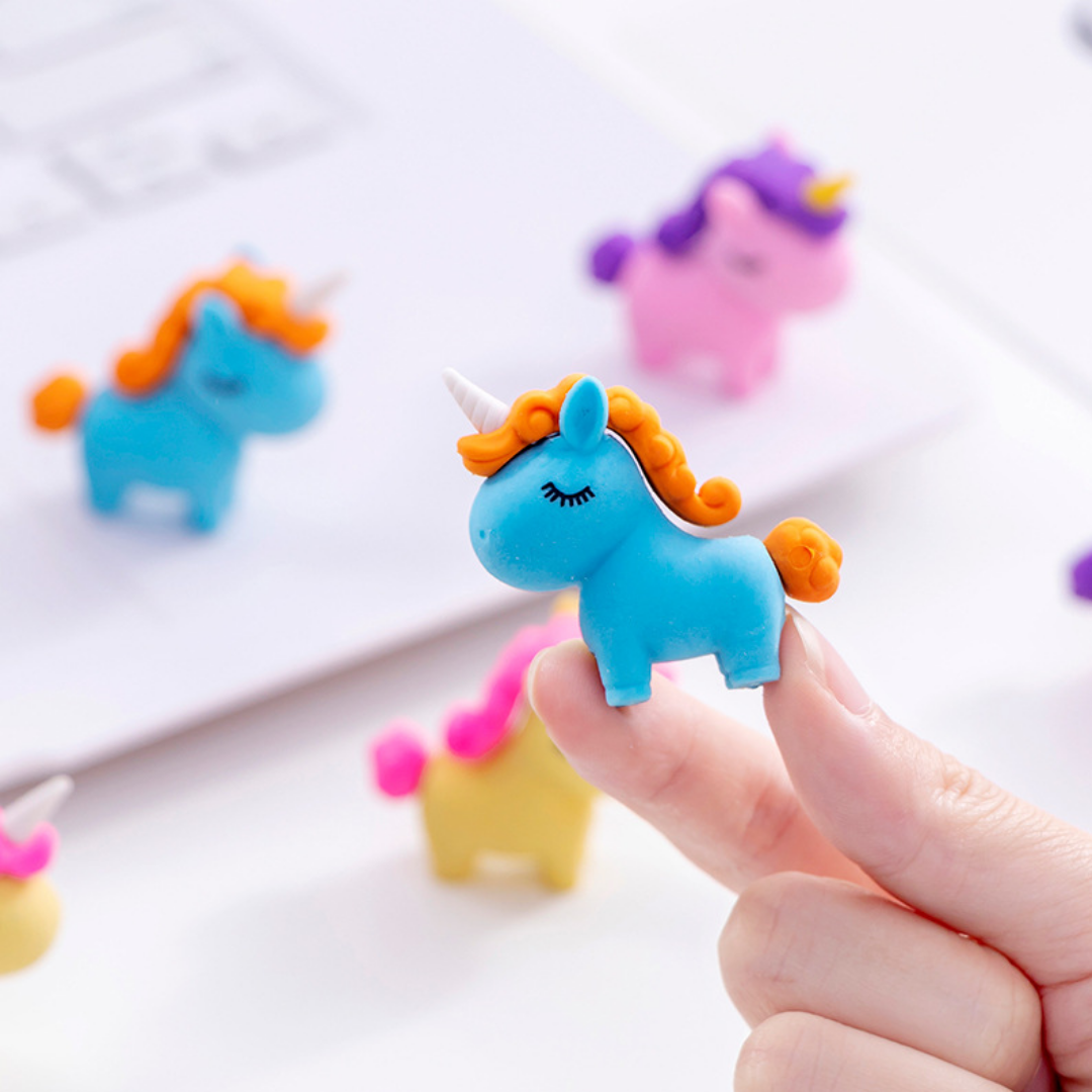 A collection of colorful 3D unicorn puzzle erasers in pastel pink, yellow, green, and blue.