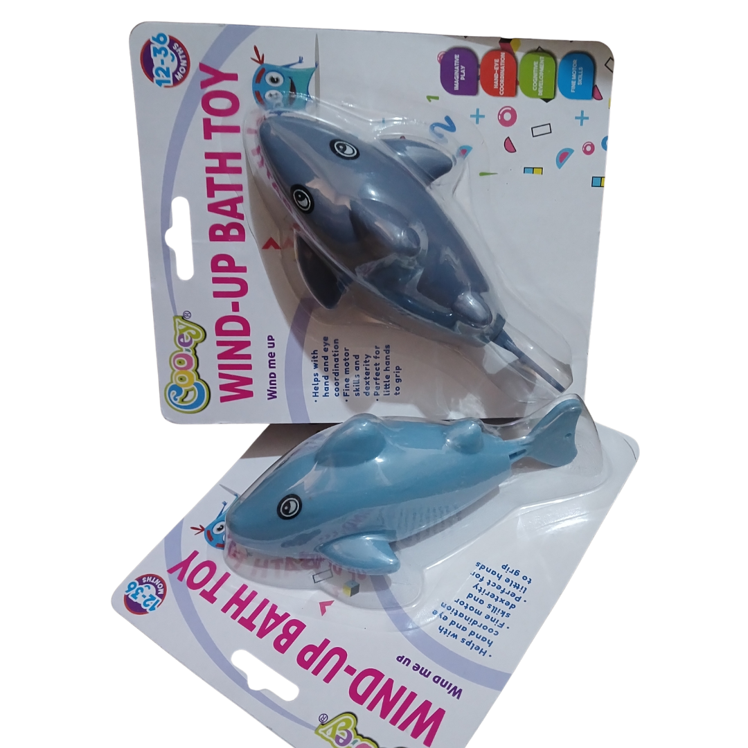 Cooey Wind-Up Bath Toys showing a green sea turtle with a black patterned shell and a sleek blue dolphin-shaped water toy on white backing cards.