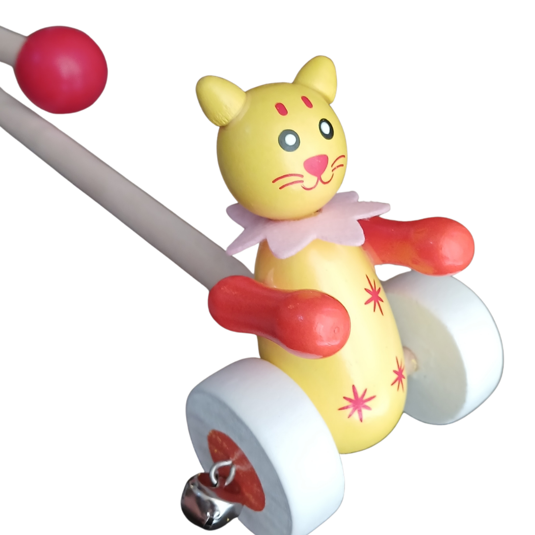 Yellow wooden cat push toy with white wheels and metal bell